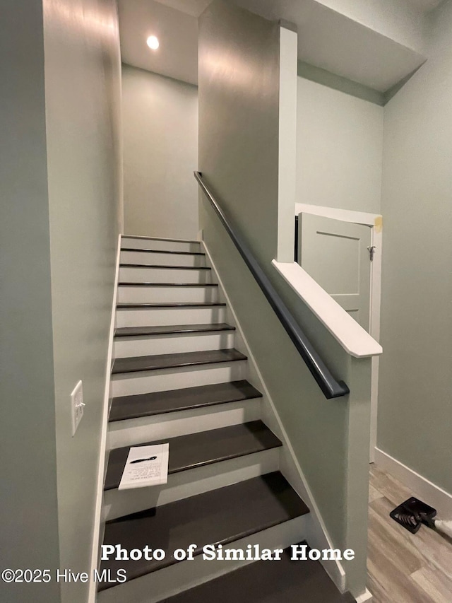 staircase with recessed lighting, wood finished floors, and baseboards