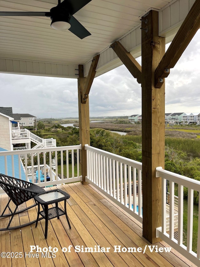 deck featuring stairway, a swimming pool, and a ceiling fan