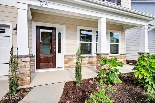 property entrance with a porch and a garage