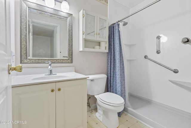 bathroom with toilet, a stall shower, and vanity