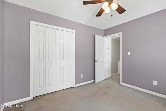 unfurnished bedroom featuring light carpet, baseboards, and a closet