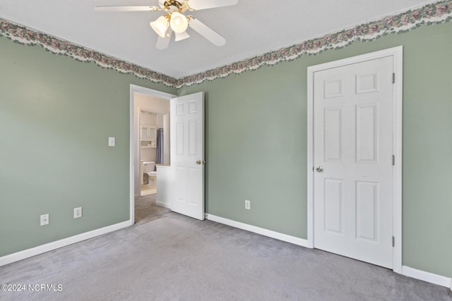 spare room featuring baseboards, a ceiling fan, and light colored carpet