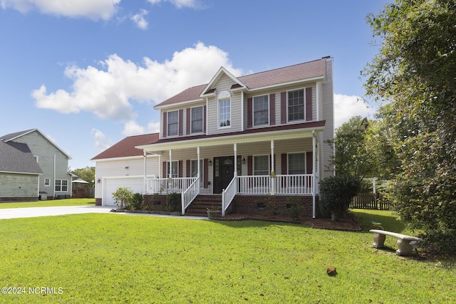 colonial house with an attached garage, driveway, a porch, and a front yard