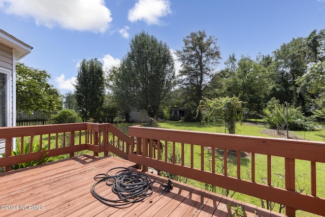 deck with fence and a yard