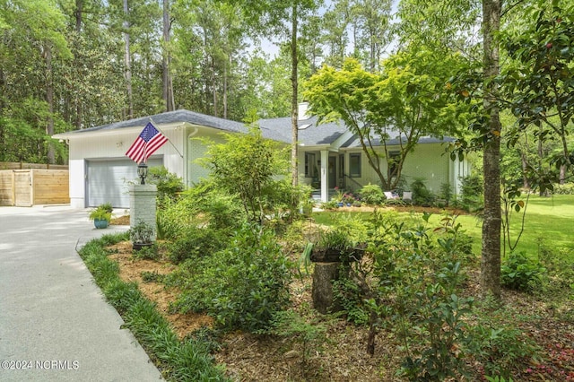view of front of property featuring brick siding, roof with shingles, a garage, and concrete driveway