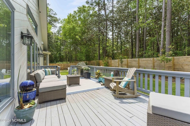 wooden deck featuring a fenced backyard and grilling area
