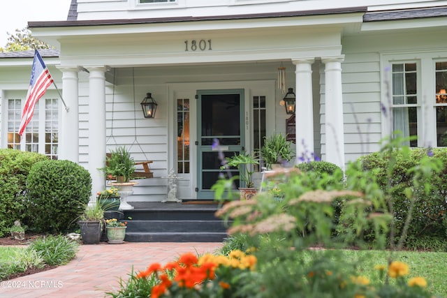 view of exterior entry with a porch