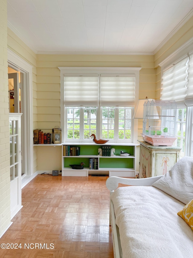 bedroom featuring ornamental molding and parquet floors