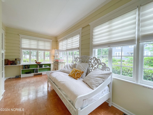 bedroom with parquet flooring and crown molding