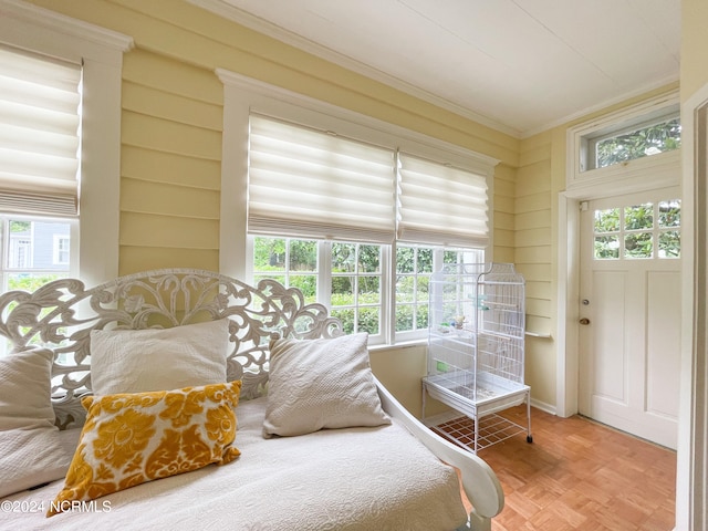 bedroom with hardwood / wood-style flooring and crown molding