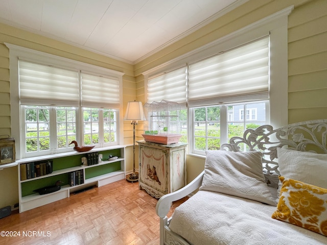 bedroom featuring light parquet flooring and crown molding