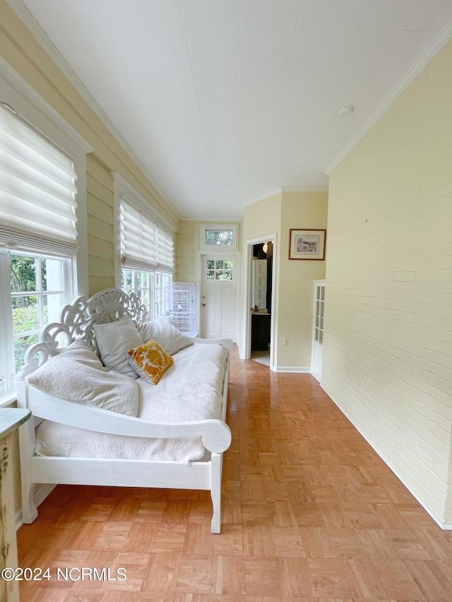 bedroom with light parquet floors and crown molding