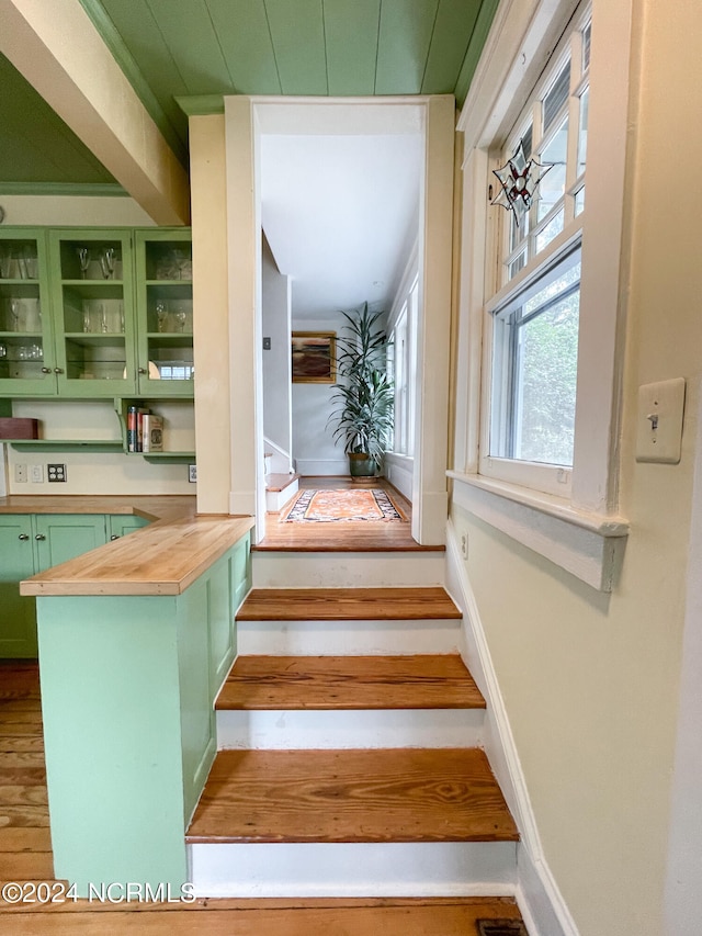 stairs with hardwood / wood-style floors