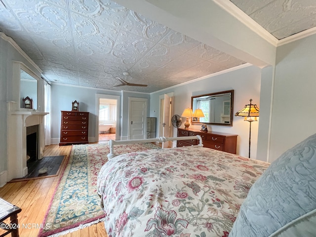 bedroom with hardwood / wood-style flooring and crown molding