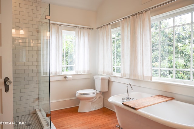 bathroom with plus walk in shower, toilet, and hardwood / wood-style floors