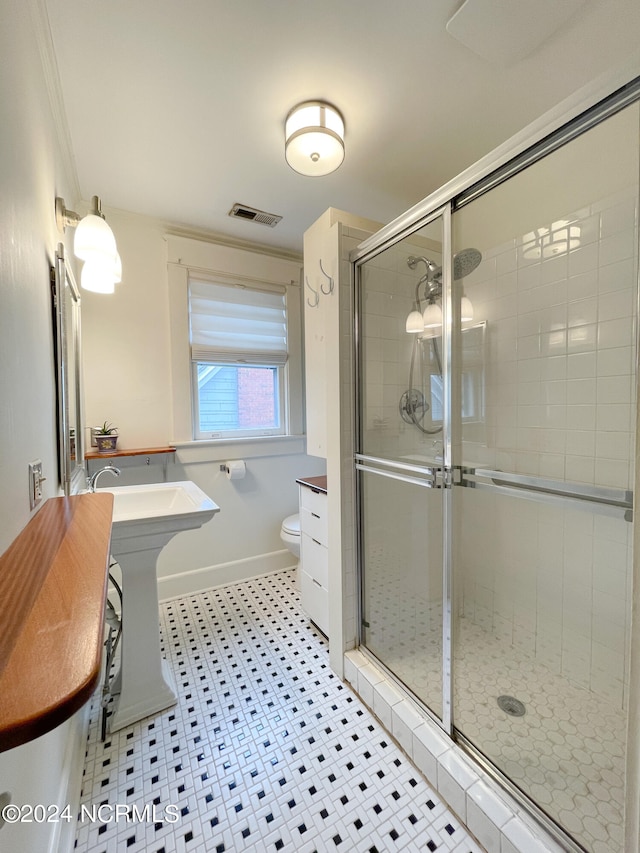 bathroom with tile flooring, ornamental molding, toilet, and vanity