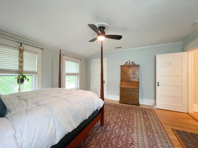 bedroom with vaulted ceiling, hardwood / wood-style floors, ceiling fan, and crown molding