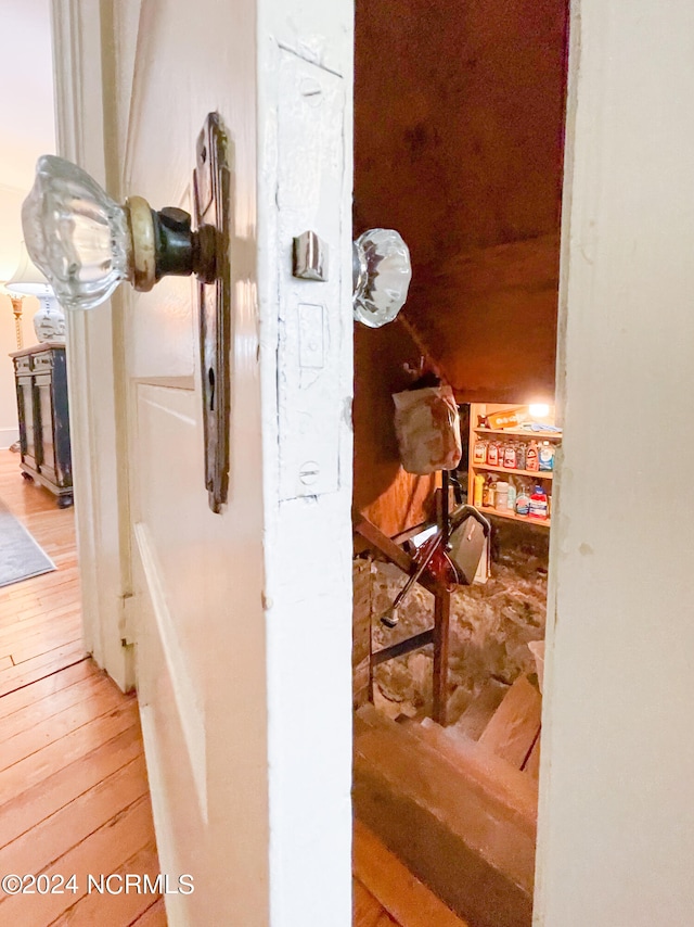 hallway with hardwood / wood-style floors