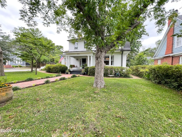 view of front of house with a porch and a front lawn