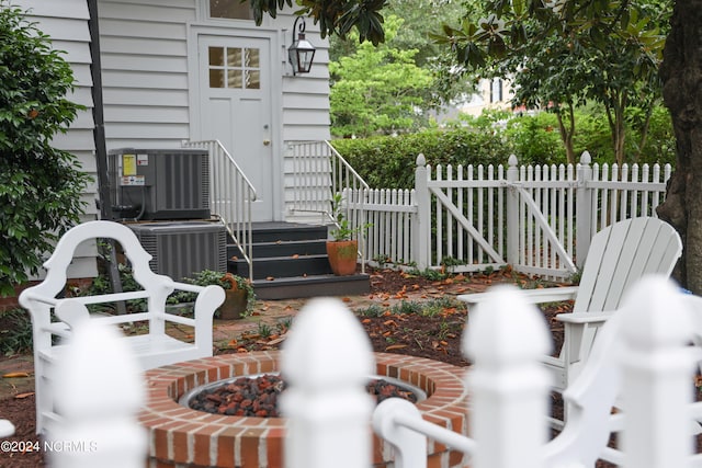 details with central AC unit and a fire pit