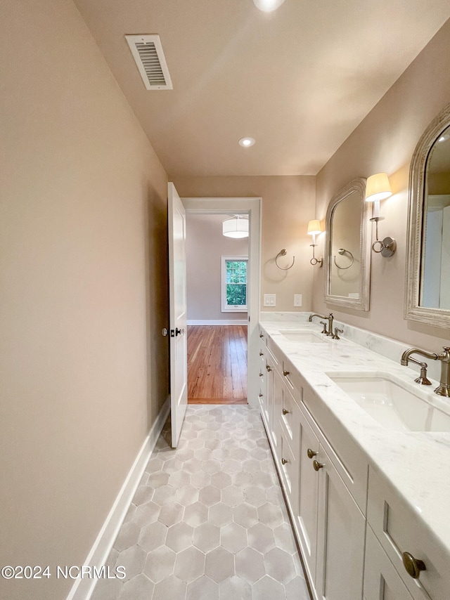 bathroom featuring tile floors and double sink vanity