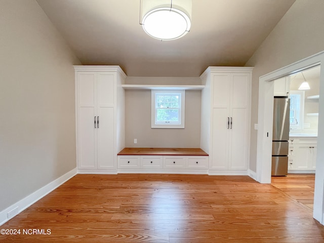 interior space with vaulted ceiling and light hardwood / wood-style floors