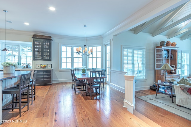 dining room featuring a chandelier, crown molding, vaulted ceiling with beams, and hardwood / wood-style floors