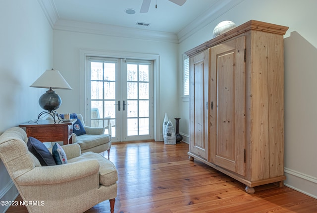 living room featuring ceiling fan, ornamental molding, french doors, and hardwood / wood-style flooring