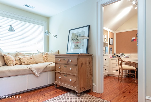 interior space with light hardwood / wood-style floors and lofted ceiling