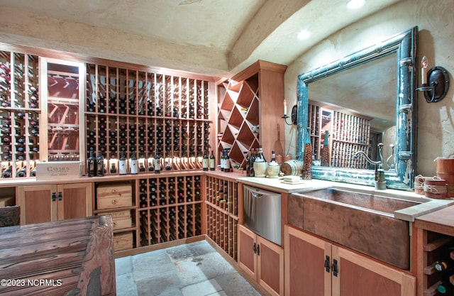 wine room with sink and light tile floors