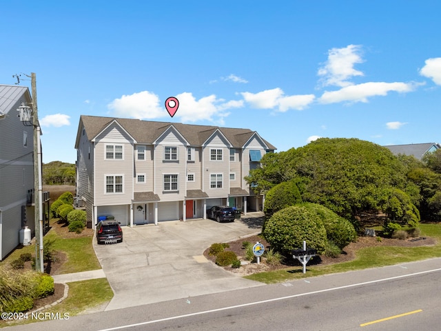 view of property featuring a garage and driveway