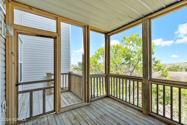 unfurnished sunroom with plenty of natural light