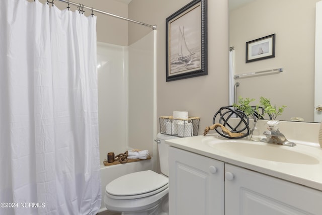 full bath with a shower with curtain, vanity, and toilet