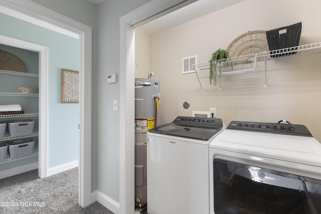 clothes washing area with laundry area, visible vents, carpet flooring, washing machine and dryer, and water heater