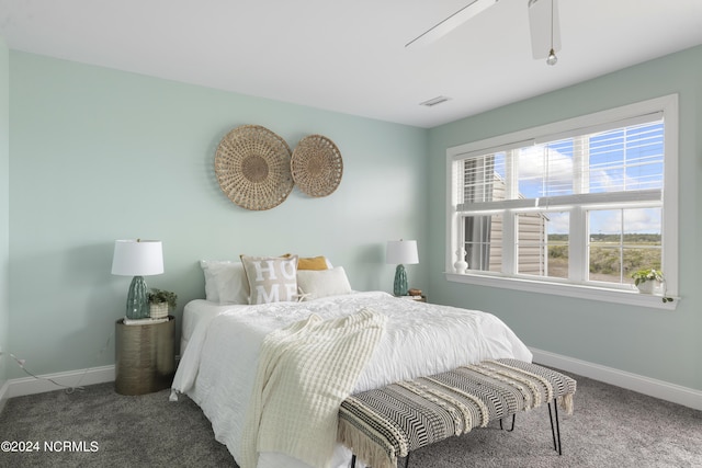 bedroom featuring a ceiling fan, carpet flooring, visible vents, and baseboards