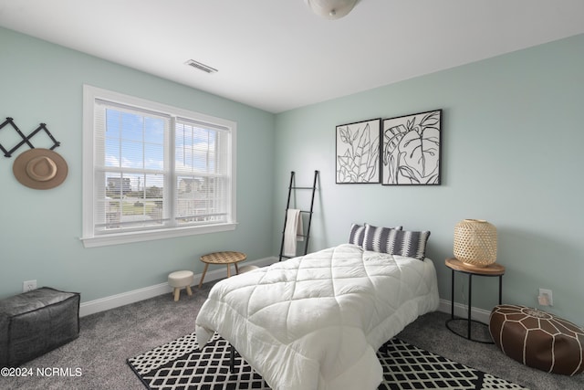 carpeted bedroom featuring visible vents and baseboards