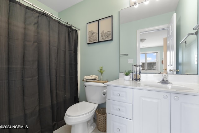 bathroom featuring toilet and vanity