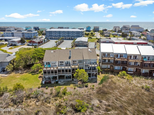 drone / aerial view with a water view and a residential view