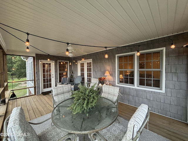 sunroom with a ceiling fan and wood ceiling