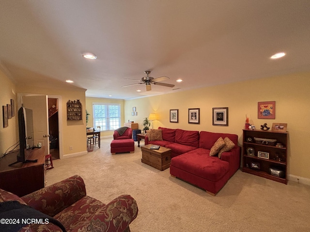 living area with baseboards, ornamental molding, recessed lighting, and light colored carpet