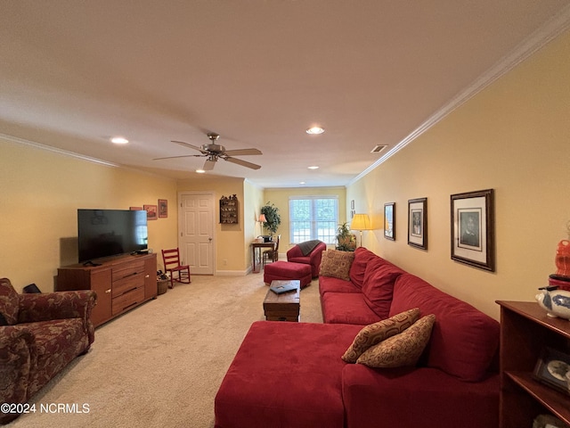 living room featuring carpet, ceiling fan, and crown molding