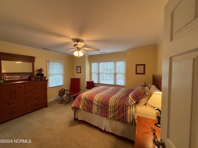 carpeted bedroom with ornamental molding, multiple windows, and ceiling fan