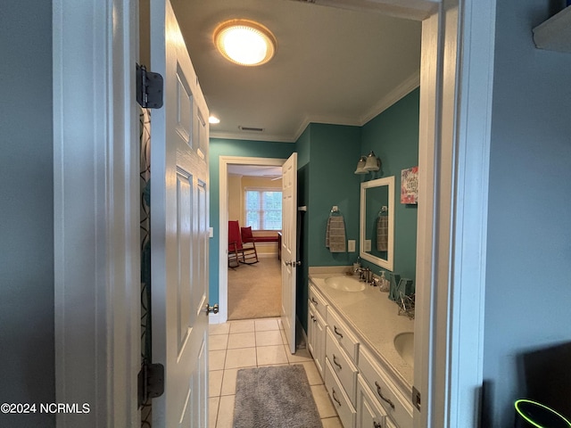 bathroom with tile patterned flooring, double vanity, and ornamental molding