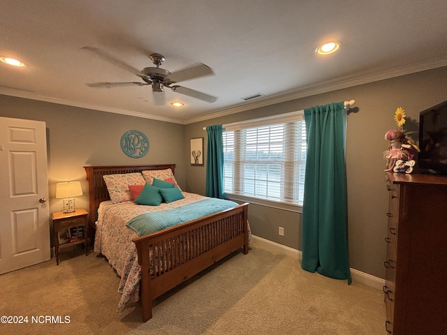 carpeted bedroom featuring crown molding and ceiling fan