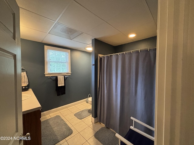 bathroom featuring a drop ceiling, vanity, and tile patterned floors