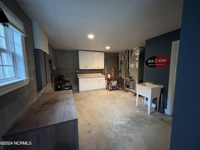 kitchen with heating unit and white cabinets