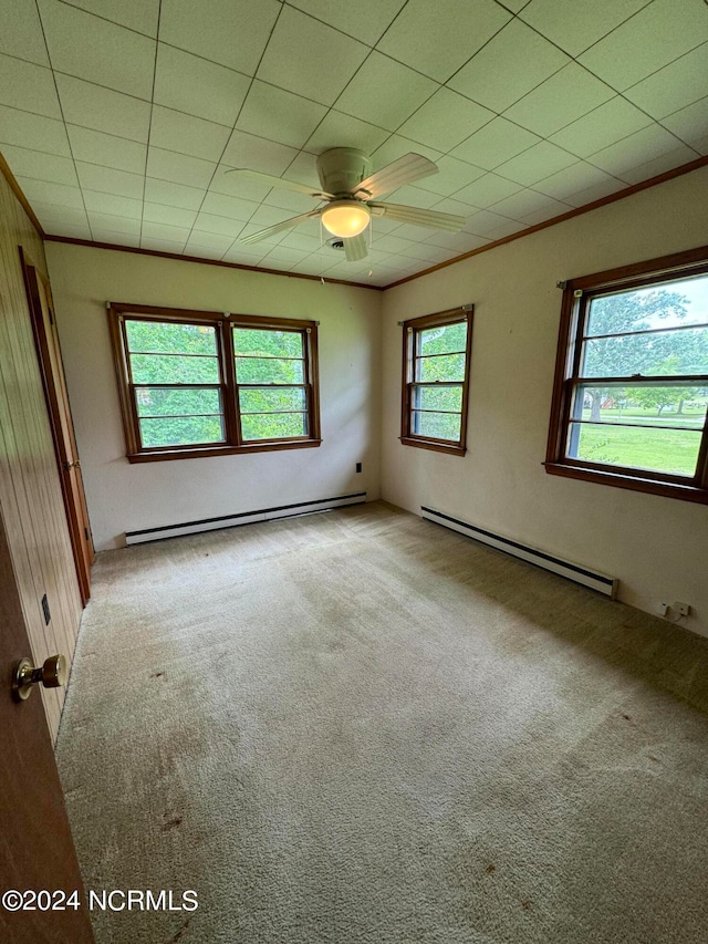 spare room with baseboard heating, carpet, and ceiling fan