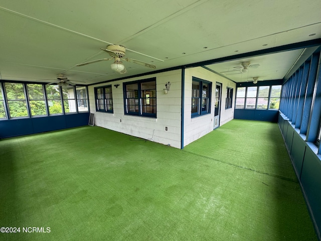 unfurnished sunroom with ceiling fan