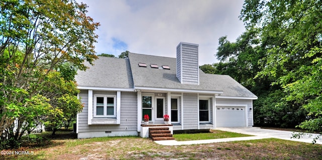 view of front of house with a front yard and a garage