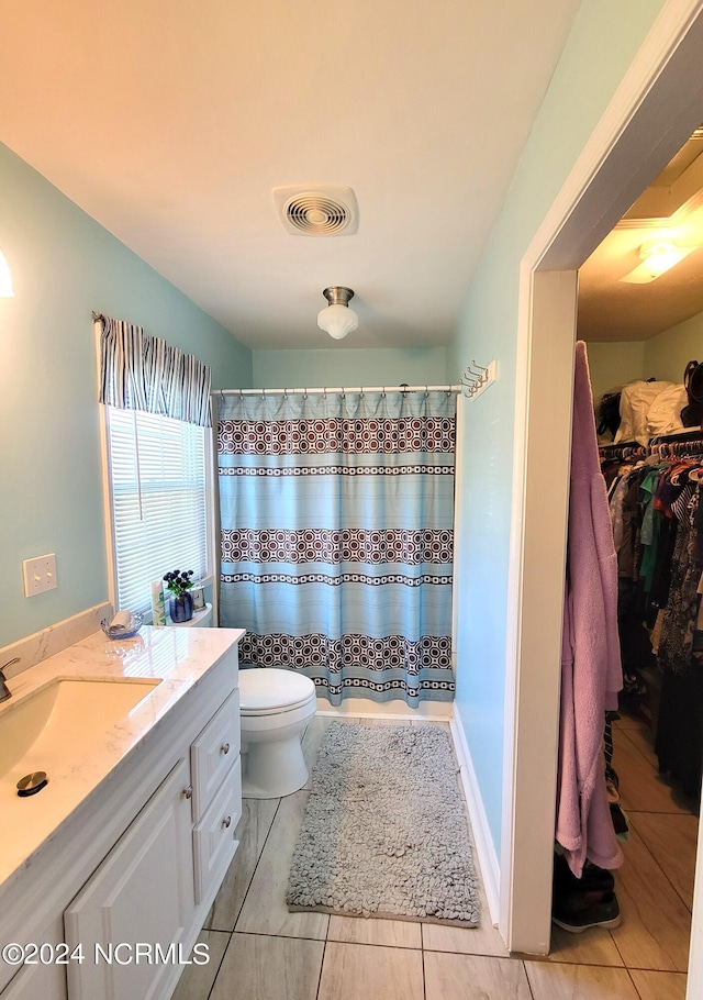 bathroom featuring vanity, toilet, and tile floors